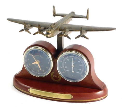 A 70th Anniversary of Avro Lancaster desk stand with aeroplane top and two dial centre with front plaque, 19cms high.