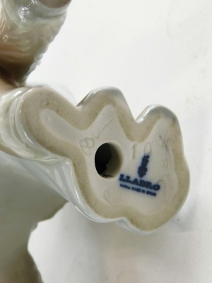 A 20thC Lladro figure group child hugging donkey, printed marks beneath, 21cm high. - 2