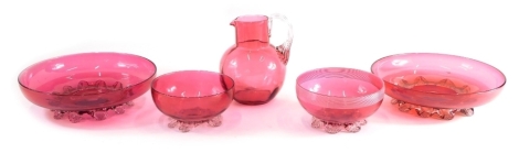 Various cranberry and ruby glassware, bowl, 14cm diameter, two various other bowls, a jug with plain glass strap work handle, etc. (a quantity)
