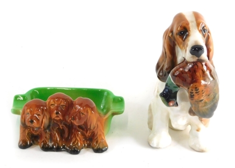 A Royal Doulton figure group gun dog and pheasant, number 1028, printed marks beneath, 15cm high, and a Beswick puppy dish, number 916. (2)