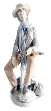 A large 20thC Lladro figure of a street musician, printed marks beneath, 34cm high, in associated box.