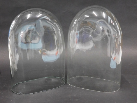 A pair of glass arched domes, 24cm high, 15cm wide, 9cm deep.