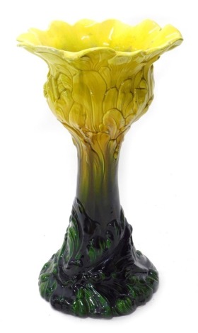 An early 20thC Bretby type Majolica jardiniere, with floral top in yellow and green glazes, unmarked.