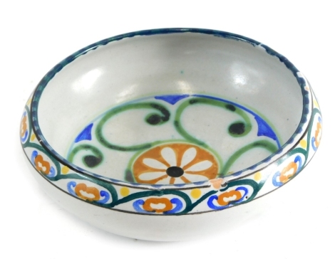 An early 20thC Collard Honiton Poole style bowl, decorated with flowers, impressed marks beneath, 16cm diameter.