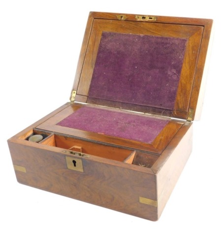 A 19thC walnut writing box, of rectangular form, with brass corners and fitted interior, with writing section, space for pens and ink bottles, with plain exterior escutcheon, 15cm high, 31cm, wide, 22cm deep.