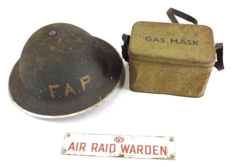 Various militaria and military items, a tin FAP helmet with leather interior and material chin strap, an ARP air raid warden enamel finished sign in red lettering 24cm wide and a gas mask tin (3).