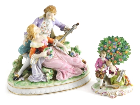 A Continental porcelain figural group of a lady and gentleman, he playing flute she holding garland, in a naturalistic setting, polychrome decorated, unmarked 15cm high and a miniature bocage group possibly Samson Paris with red anchor mark beneath. (2)