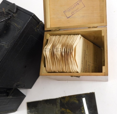 An early 20thC pressed leather box camera, various glass slides country houses, figures etc contained in a dovetailed box. - 3