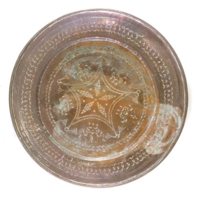 A large Eastern copper charger, with an outer figure of eight border, and inner floral decoration, 76cm diameter.