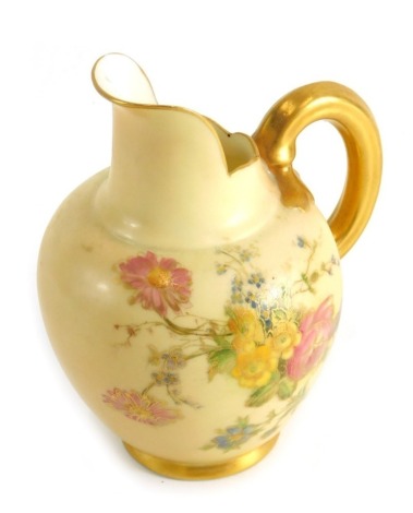 An Edwardian Royal Worcester porcelain blush ivory jug, with shaped spout, strap work handle and bulbous body hand painted with flowers, pink marks beneath, c.1903, 12cm high.