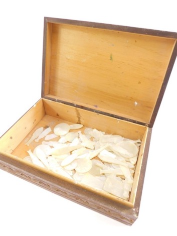 Various 19thC mother of pearl gaming counters, fish shaped, etc, in a carved Eastern box, 25cm wide.