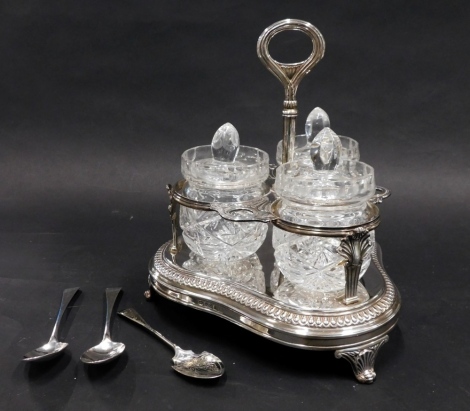 A George III silver preserve stand, with three associated cut glass lidded jars with and silver spoons, on a tricorn base terminating in scroll feet, with central handle, London 1809, 19oz, 31cm high.