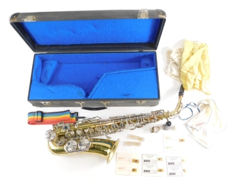 An Elkhart brass saxophone, with mother of pearl and chrome buttons, marked Bach International, with removable mouthpiece, in fitted case, the case 60cm wide.