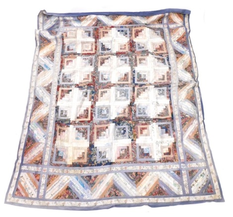 An early 20thC patchwork quilt, made of a quantity of scrap and other floral sections, in colours, decorated with many flowers, etc.