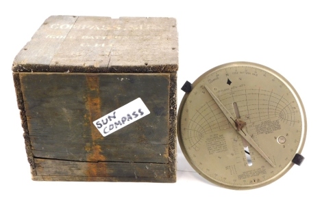 A 20thC sun compass with metal plate top 23cm diameter partially boxed.