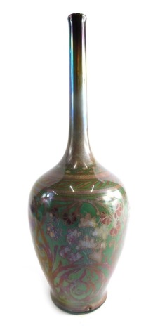 An early 20thC Royal Lancastrian lustre pottery bottle vase, with slender stem and shouldered body decorated with flowers probably by Charles Cundall, numbered 2572 c.1909, 27cm high.