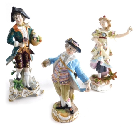 An early 20thC Meissen porcelain figure of a gentleman, dressed in finery polychrome decorated with multi coloured waistcoat on, a gilt highlighted ground fronting a tree bough blue crossed sword mark beneath 16cm high (AF) and two further continental por