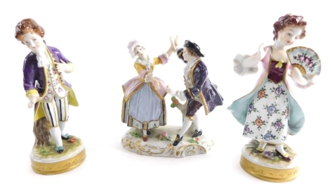 A pair of Continental porcelain figure groups of a boy and girl, each dressed in finery, he wearing stripped pantaloons, she holding fan, on naturalistic bases with gilt highlights, blue GR marks beneath, 15cm high, and a further Sitzendorf figure group o