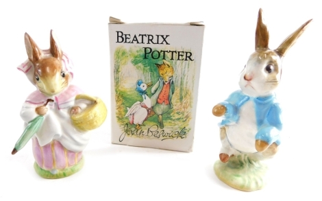 A Beswick pottery Beatrix Potter figure Mrs Rabbit, gold oval mark beneath, 9cm high, and Peter Rabbit. (2, with one box AF)