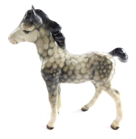 A Beswick foal, in rocking horse grey, marked beneath, 10cm high.