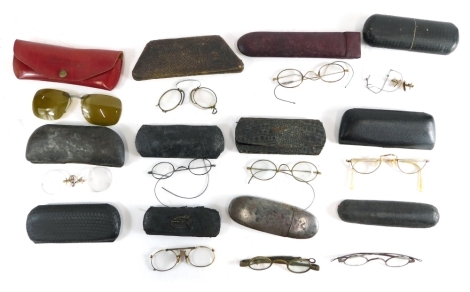 Various optical items and spectacles, a spectacles case containing a pair of gilt coloured half moon spectacles, with curved side bars, the case 14cm wide, various other spectacles cases, metal case, other gilt coloured rimmed spectacles, pince nez, vario