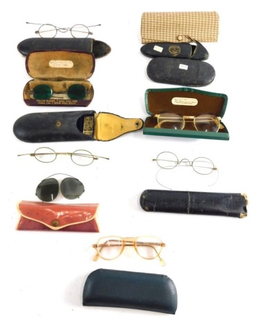 Various optical items and spectacles, iron rimmed pair of spectacles with plain side bars, in case, 17cm long, Francis Musson case, with iron eye protectors with green tinted lenses, various other cases, spectacles, etc. (a quantity)