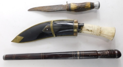 A cow horn handled kukri, with shaped scabbard with metal embellishment compressed handle and shaped blade 33cm long, an early 20thC dagger and sheath and a further dagger with horn handle and compressed metal pommel (3). - 2