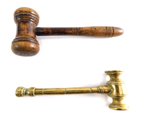 Two gavels, comprising one in brass, 15cm long, and a turned wooden gavel. (2)