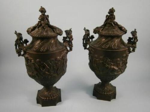 A pair of late 19thC / early 20thC bronze two handled urns and covers