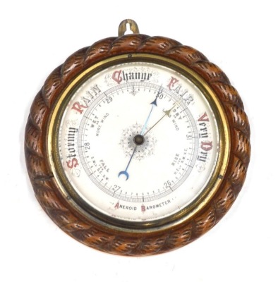 A 20thC oak cased wall barometer, with 17cm diameter dial, in rope twist surround.