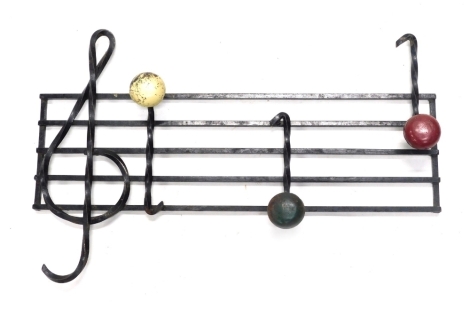 A retro iron coat stand formed as music notes, 60cm wide.