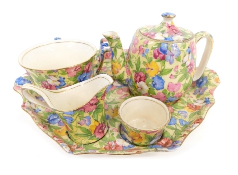 A Royal Winton Chintz Sweetpea pattern Countess tea for one set, comprising teapot, 10cm high, cup, milk jug, saucer and toast rack on stand, printed marks beneath. (a quantity)