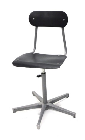 An early 20thC industrial machinist Singer style chair, with oblong back in grey metal with shaped seat articulated and adjustable stem on a five spoke base unmarked 57cm wide.