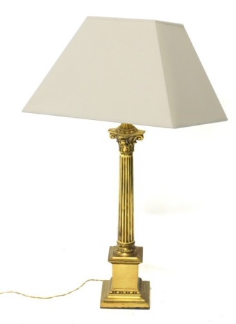 A brass table lamp, with classical column, on stepped base with modern electric fitting and cream shade, 82cm high. Buyer Note: WARNING! This lot contains untested or unsafe electrical items. It is supplied for scrap or reconditioning only. TRADE ONLY