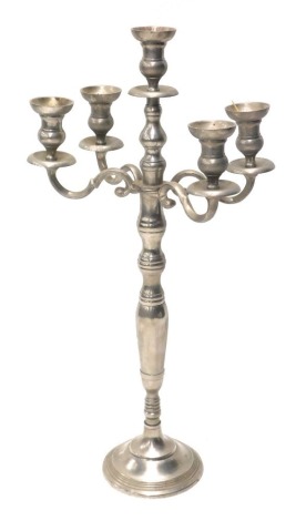 A modern silver coloured four branch candelabrum, with central dish holder, on baluster stem and circular foot, with four scroll branches, 85cm high.