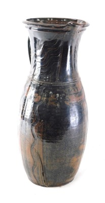 A 20thC Studio pottery jug, sgrafito decorated, with seal mark to the body, 55cm high. (AF)