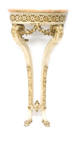 A Continental white painted and parcel gilt wood console table, the pink variegated marble demi lune top, above a pierced frieze, on two shaped legs embellished with swags, leaves, etc., and hoof feet, 88cm high, 42cm wide, 26cm deep.