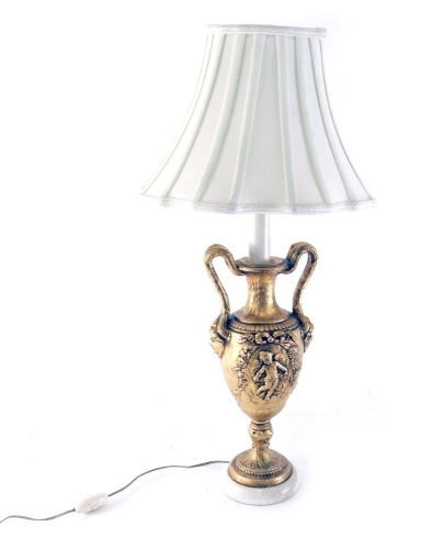 A classical design urn table lamp, with double strap work handles, with a mask head and raised cherub decoration on circular foot with modern shade 71cm high. Buyer Note: WARNING! This lot contains untested or unsafe electrical items. It is supplied for s