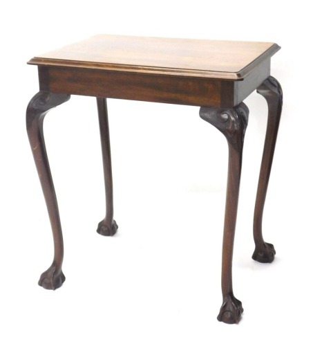 A mahogany side table, the rectangular top raised above heavily carved cabriole legs terminating in ball and claw feet, 81cm high, 71cm wide, 50cm deep.