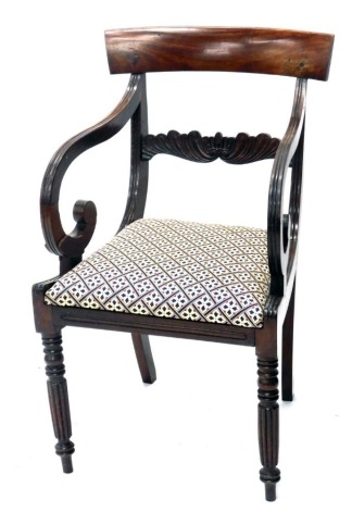 A Regency mahogany carver chair, with floral back splat, drop in seat in later floral Regency style material, on fluted front and sabre back legs, 89cm high.