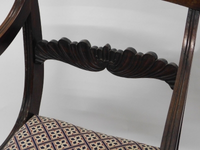 A Regency mahogany carver chair, with floral back splat, drop in seat in later floral Regency style material, on fluted front and sabre back legs, 89cm high. - 2