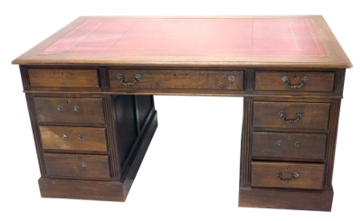 A 20thC oak twin pedestal desk, with tooled red leather top above an arrangement of drawers, on block base, with panelled sides, 80cm high, 153cm wide, 84cm deep. (AF)