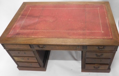 A 20thC oak twin pedestal desk, with tooled red leather top above an arrangement of drawers, on block base, with panelled sides, 80cm high, 153cm wide, 84cm deep. (AF) - 2