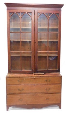 A 19thC library bookcase of large proportion, the fixed cornice raised above a pair of glazed doors with mitre glazing bars, on a pine base with three drawers on splayed feet, 170cm high, 140cm wide, 58cm deep. (AF, a marriage)