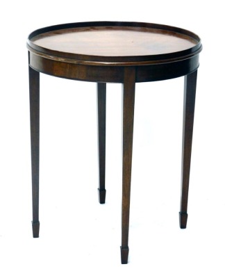 An early 20thC mahogany occasional table, the circular galleried top raised on square tapering legs terminating in spade feet, 57cm high, 47cm diameter.