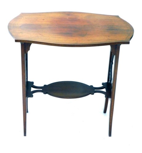 An Edwardian mahogany occasional table, the shaped top with a double line inlay, above lyre supports, joined by an oval under tier, on sabre legs, 71cm high, 80cm wide, 48cm deep.