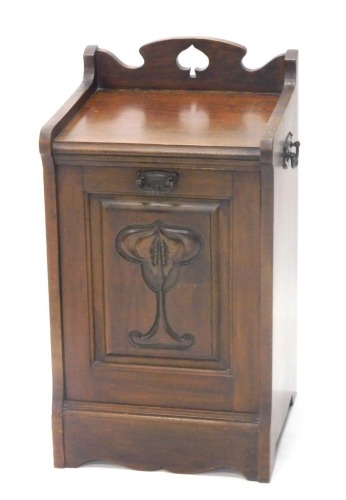 An Edwardian Art Nouveau coal purdonium, with three part galleried top, hinged front, with lead lined interior and shovel, with carved lotus leaf panel, 68cm high, 36cm wide, 35cm deep.