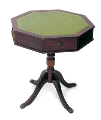 A 20thC mahogany drum table, with tooled leather top and frieze drawers, on turned stem terminating in quadruple fluted legs with metal hair paw feet, 56cm high, 57cm wide, 51cm deep.