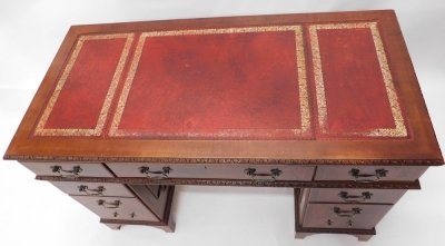 A 20thC mahogany pedestal desk, with three part tooled red leather top, raised above three frieze drawers and six pedestal drawers, locks stamped SC&S, 77cm high. - 2