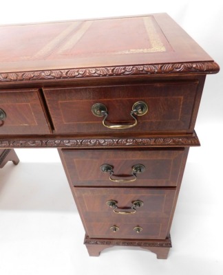 A 20thC mahogany pedestal desk, with three part tooled red leather top, raised above three frieze drawers and six pedestal drawers, locks stamped SC&S, 77cm high. - 3